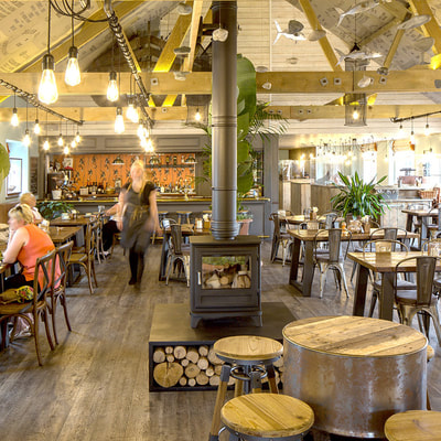Loveday's Shipwreck themed restaurant, with wood burner, industrial lights and barrel table.